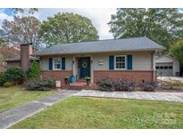 Brick ranch home with a charming front porch, landscaping, and a two-car garage at 620 N Oak St, Lincolnton, NC 28092