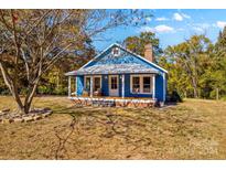Charming blue house with a spacious front porch at 480 Wyatt Grove Church Rd, Gold Hill, NC 28071