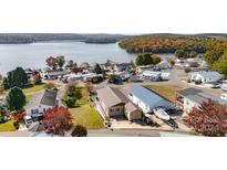 Aerial view of lakefront property with homes and boats at 127 Lake View Dr, New London, NC 28127