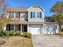 Two-story house with gray siding, two-car garage, and landscaping at 620 Smokehouse Ln, Albemarle, NC 28001