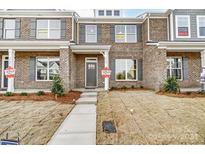 Available townhome with brick exterior, front yard, and walkway at 5540 Stafford Rd # 31, Charlotte, NC 28215