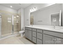 Modern bathroom with double vanity, shower, and toilet at 1710 Blanche St, Charlotte, NC 28262