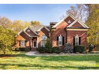 Brick home with large windows and landscaping at 11411 Home Place Ln, Mint Hill, NC 28227