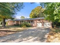 Brick ranch house with a two-car garage and landscaping at 1102 W Elm St, Shelby, NC 28152