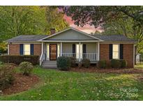 Brick ranch house with covered porch and mature landscaping at 520 Briar Creek Rd, Gastonia, NC 28056