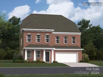 Two-story brick home with a two-car garage and front porch at 4476 Potter Wheel Dr, Fort Mill, SC 29715