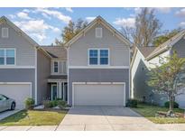 Two-story townhome with gray siding and a two car garage at 14034 Clayborn St # 28, Midland, NC 28107