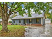 Charming ranch home with mature trees and a large driveway at 1915 Wedgedale Dr, Charlotte, NC 28210