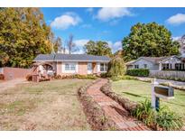 Brick ranch home with landscaped yard and brick walkway at 834 Brookwood Dr, Mooresville, NC 28115