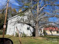Two-story white house with mature trees, needs some landscaping at 1500 N Main St, Salisbury, NC 28144