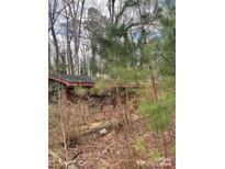 Brick house nestled in a wooded area, needs some landscaping at 327 Lineberry St, Troy, NC 27371