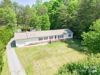 Single-story home with attached garage and large yard at 1668 Lane Rd, Mount Holly, NC 28120