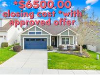 One-story home with gray siding, blue garage doors, and landscaped lawn at 131 Chimney Rock Ct, Denver, NC 28037