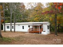 White mobile home with wooden porch at 2869 9Th Se Ave, Hickory, NC 28602