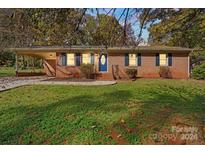 Brick ranch home with landscaped yard and attached carport at 137 Brady Ln, Statesville, NC 28625