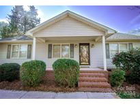 Ranch style home with brick steps and landscaping at 100 Christopher Ave, Mount Holly, NC 28120