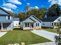 Newly built home with gray siding, brick accents, and a front porch at 606 Meadow Ave, Spencer, NC 28159