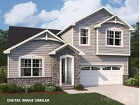 Two-story house with gray siding, stone accents, and a two-car garage at 9847 Quercus Ln, Huntersville, NC 28078