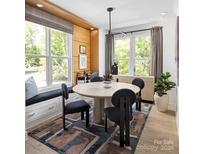 Bright dining area with built-in window seat and round table at 2051 Clarksdale Dr # 29, Charlotte, NC 28206