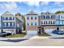 Modern 3-story townhome with 2-car garage, and neutral tones at 303 Grove Gate Ln, Indian Trail, NC 28079
