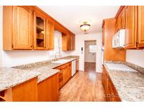 Bright kitchen with wood cabinets and granite countertops at 198 Dunlap Loop, Statesville, NC 28625