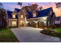 Brick home with three-car garage and manicured landscaping at 2522 Green Point Ln, Denver, NC 28037