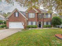 Brick two-story house with a large front yard and attached two-car garage at 591 Gatsby Nw Pl, Concord, NC 28027