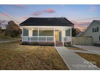 Charming craftsman style home with a front porch and landscaped yard at 102 S Liberty St, Gastonia, NC 28052