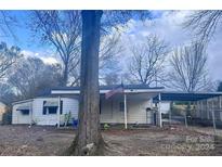 Single-story home with covered front porch, carport, and fenced backyard at 1060 Mcdow Dr, Rock Hill, SC 29732