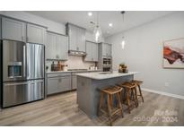 Modern kitchen with gray cabinets and an island at 1186 Lost Cove Rd, Indian Land, SC 29707