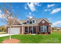 Brick ranch house with a two-car garage and landscaped yard at 4812 Weber Ct, Gastonia, NC 28056