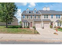 Two story townhome with stone exterior, two car garage, and landscaping at 9510 Birkwood Ct, Charlotte, NC 28278