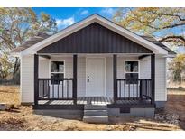 Newly renovated home features a charming front porch and gray siding at 113 Dellinger Rd, Shelby, NC 28152