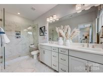 Modern bathroom with double vanity, marble shower, and stylish decor at 3244 Stelfox St, Charlotte, NC 28262