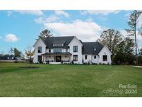 Stunning two-story home with a white exterior, gray roof and a spacious lawn at 1017 Maxwell Ct # 5, Marvin, NC 28173