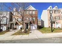 Brick front exterior of charming townhome with two-car garage at 14125 Winford Ln, Charlotte, NC 28262