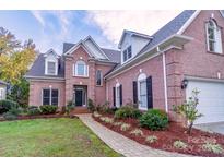 Brick home with a two-car garage and landscaped yard at 17418 Sailors Watch Pl, Cornelius, NC 28031