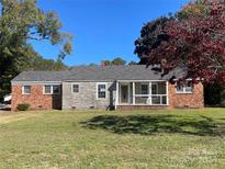 Brick ranch house with a covered porch and large yard at 223 Chester Ave, Great Falls, SC 29055