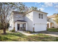 Two-story house with a white garage door and landscaping at 12413 Stowe Acres Dr, Charlotte, NC 28262