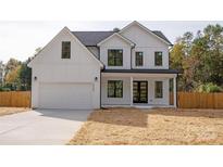 Stunning two-story white house with black accents and a large yard at 9000 Boyd Dr, Matthews, NC 28105