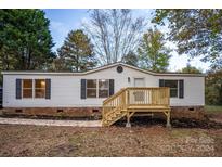 Single-wide mobile home with new wooden deck and landscaping at 7807 High Terrace Ln, Denver, NC 28037