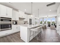 Modern kitchen with island, stainless steel appliances, and hardwood floors at 3236 Stelfox St, Charlotte, NC 28262