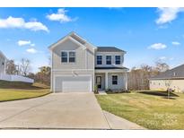 Two-story house with a gray exterior, two-car garage, and a well-maintained lawn at 183 Sugar Hill Rd, Troutman, NC 28166
