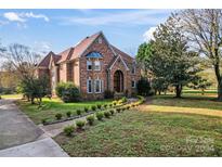 Two story brick house with manicured lawn at 431 Walden Trl, Waxhaw, NC 28173