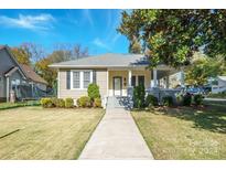 Charming yellow bungalow with front porch and landscaped yard at 402 W 7Th St, Newton, NC 28658