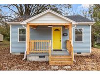 Newly renovated home featuring a charming front porch and yellow door at 647 Simpson St, Rock Hill, SC 29730