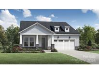One-story home with gray siding and white garage door at 5351 Mint Harbor Way # 0303, Charlotte, NC 28269