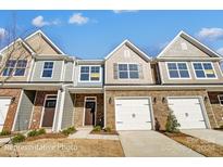 Three-unit townhouse building with attached garages at 6259 Tea Olive Dr # 178, Harrisburg, NC 28075