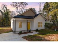 Newly built home with yellow door and small porch at 1412 10Th St, Statesville, NC 28677