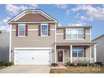 Two-story house with a white garage door and brown siding at 1628 Savory Ln, Charlotte, NC 28216